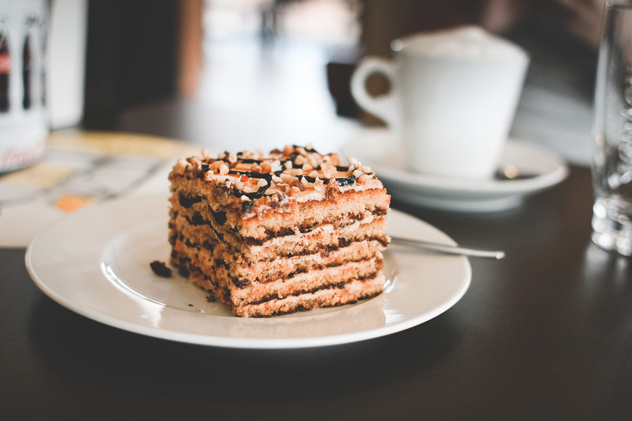 A piece of cake on top of a white plate.