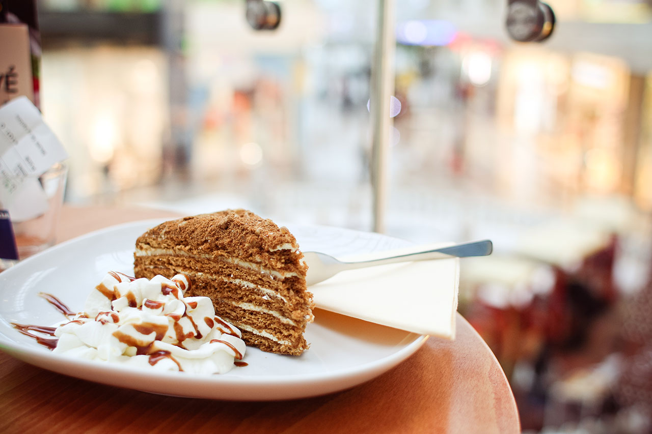 A piece of cake on top of a white plate.