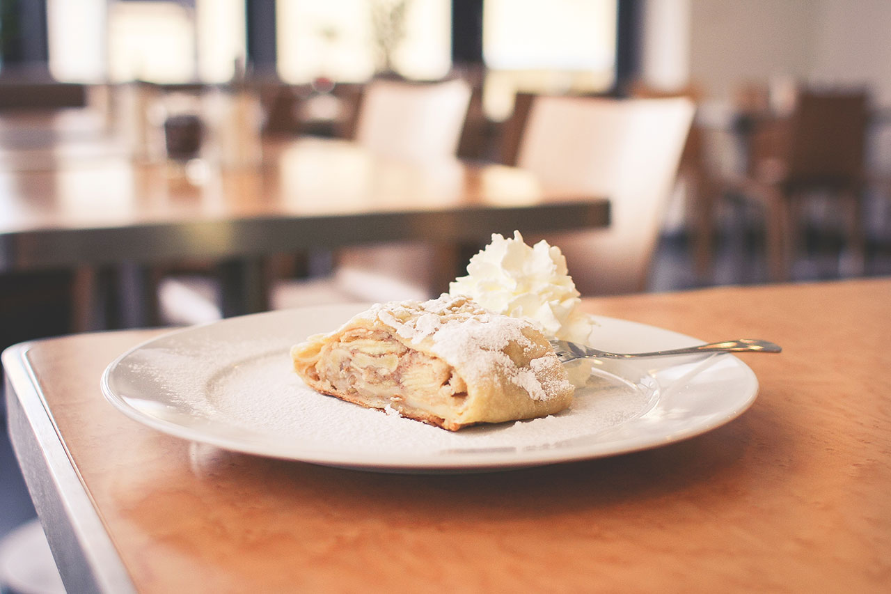 A white plate topped with food on top of a table.