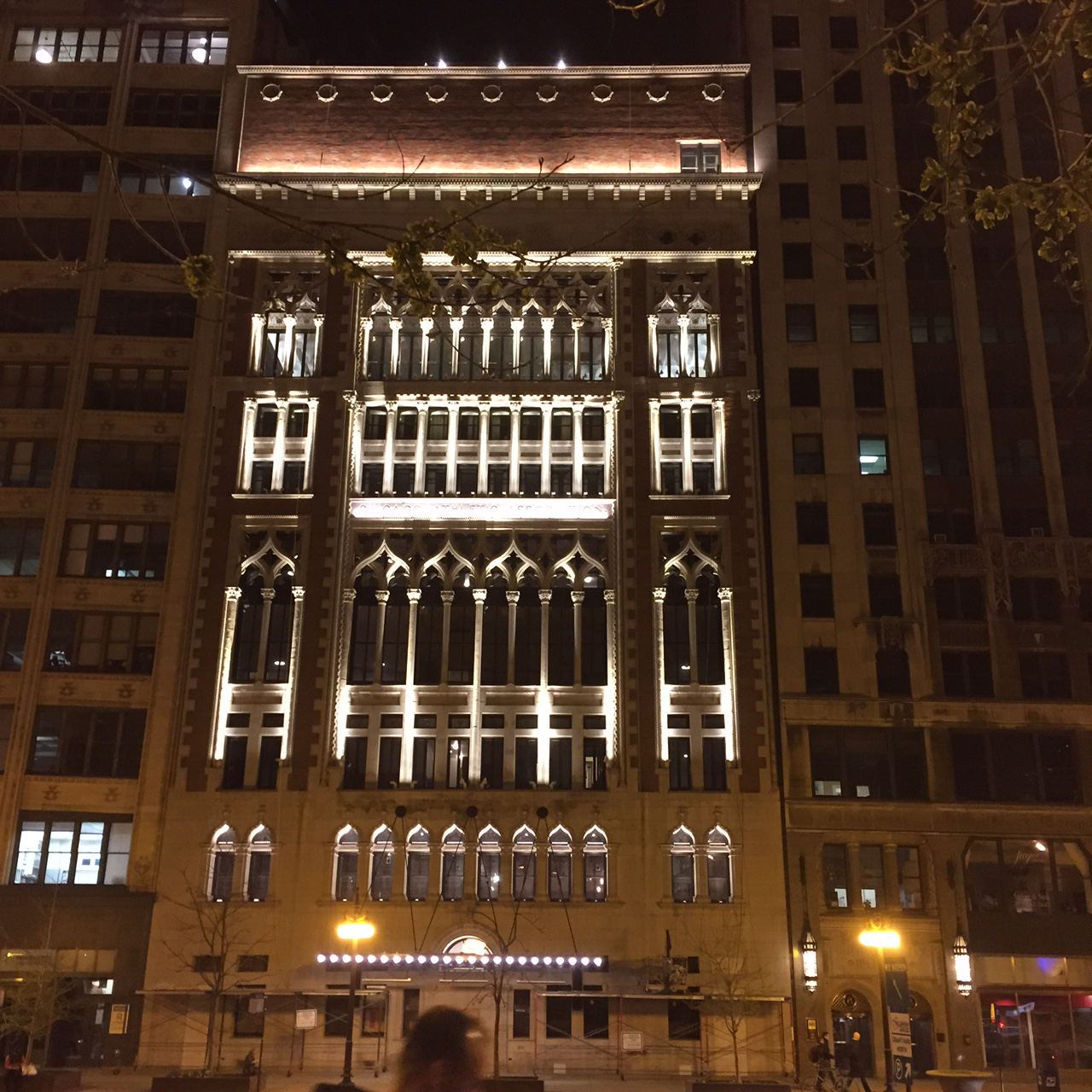 A building with lights on it's side at night.