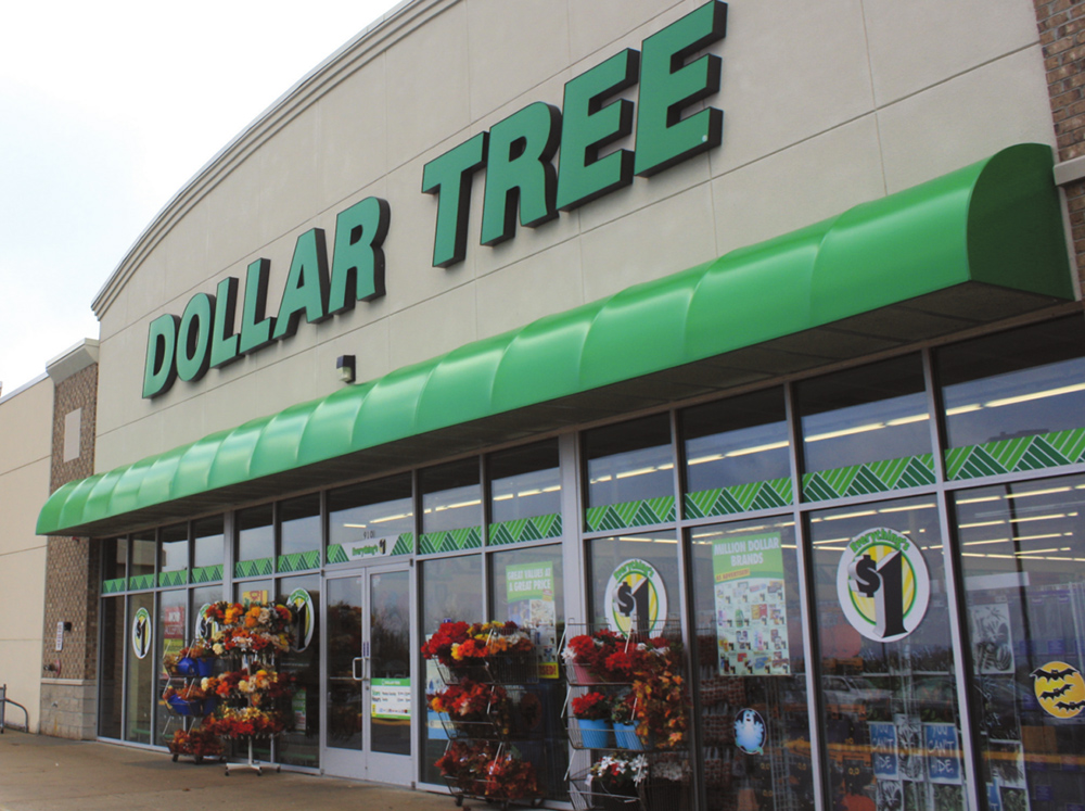 A dollar tree store front with many items on the outside.