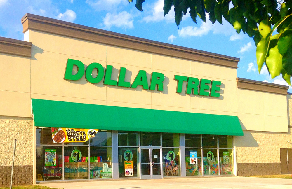 A dollar tree store front with green lettering.