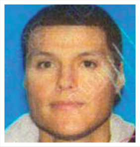 A man with short hair and a white shirt.