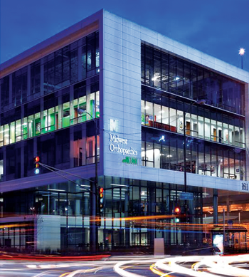 A large building with many windows and lights