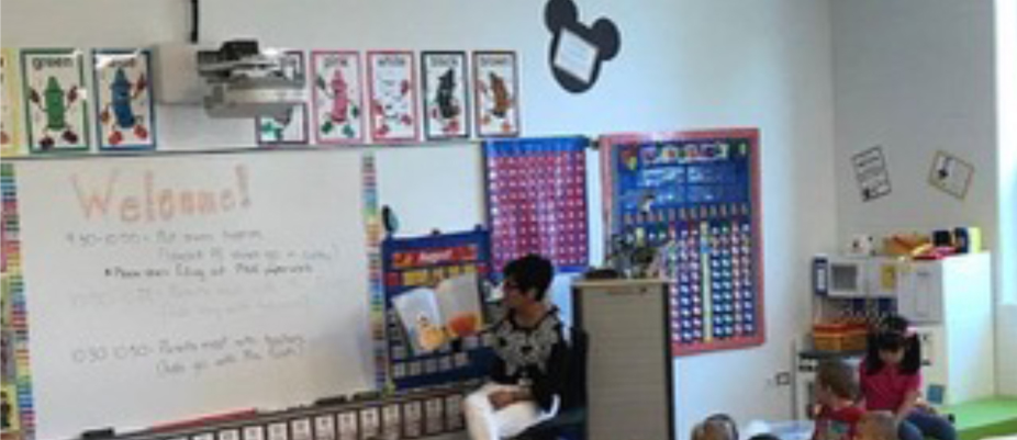 A child sitting in front of a whiteboard.