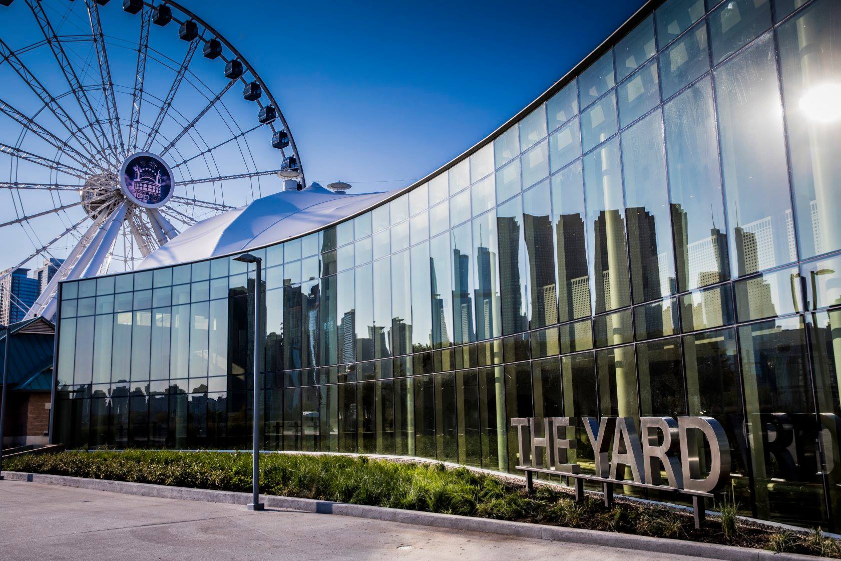 A large building with a ferris wheel in the background.
