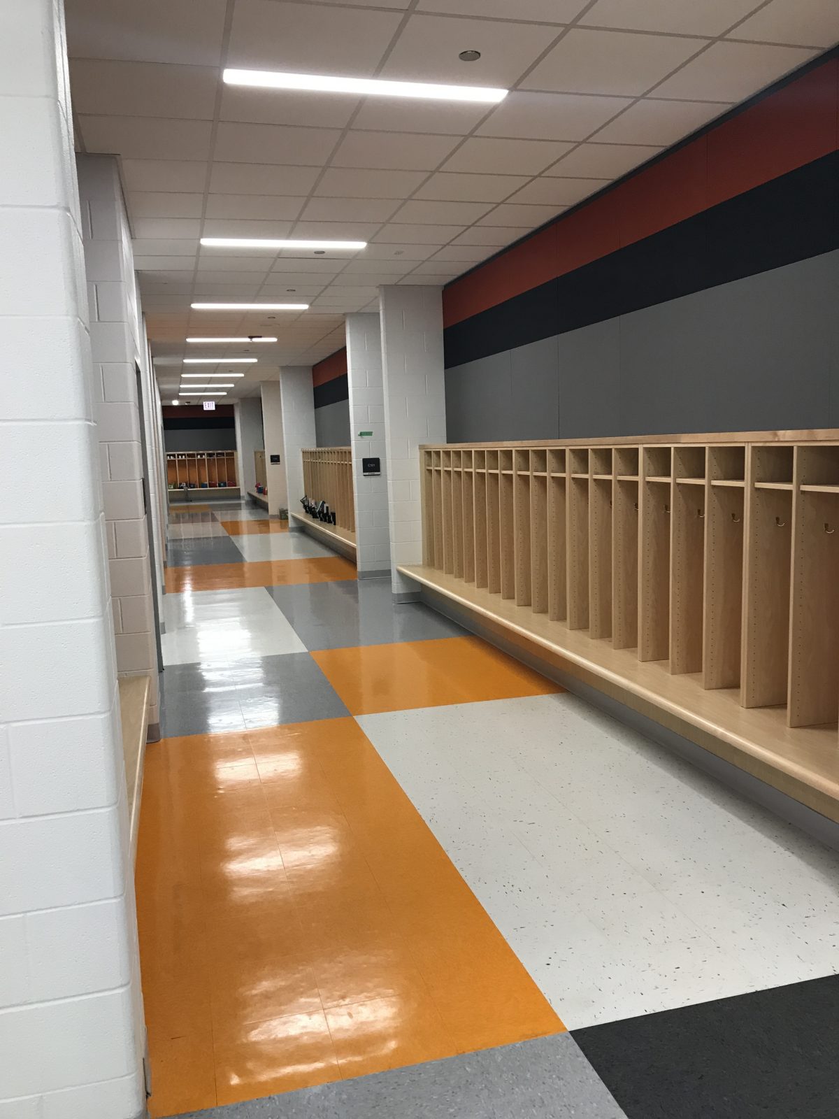 A hallway with orange and white walls.