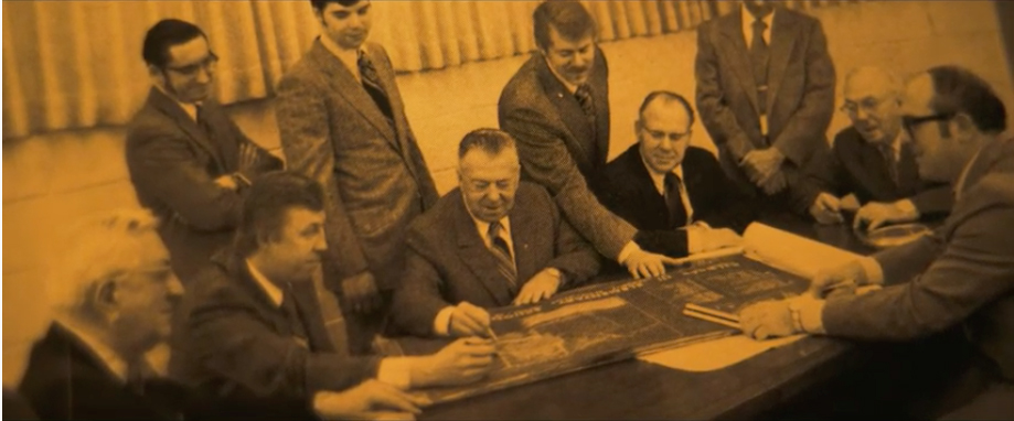 A group of men sitting around a table.