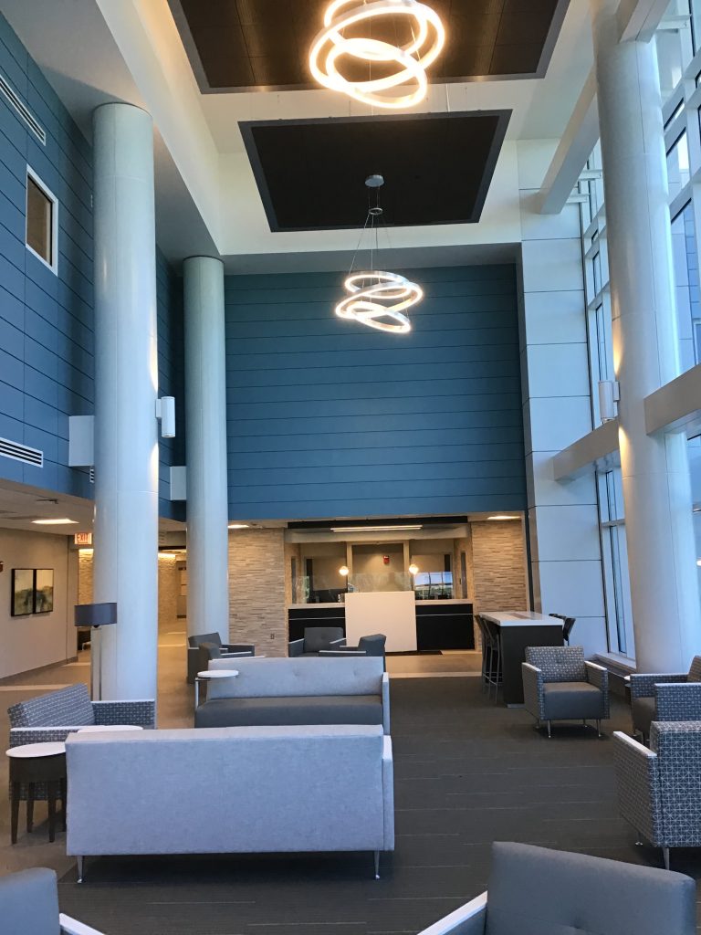 A lobby with couches and tables in it